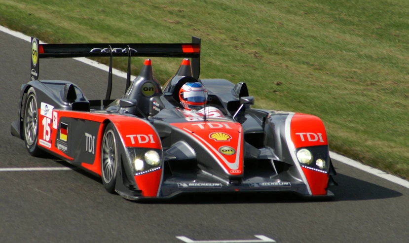 a red racing car driving on the road