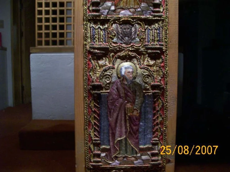 the gold, carved panel depicts a st benedict and his son in white robes