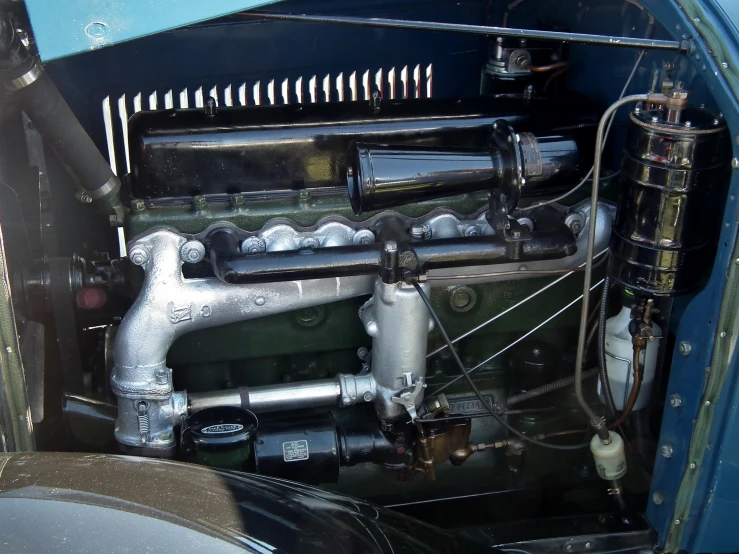 an antique engine with metal pipes and no top cover