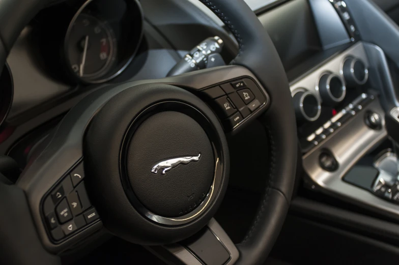 the interior of a car with black leather and a steering wheel