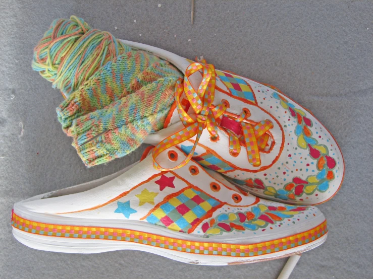 a pair of sneakers with colorful decorations and crocheted socks