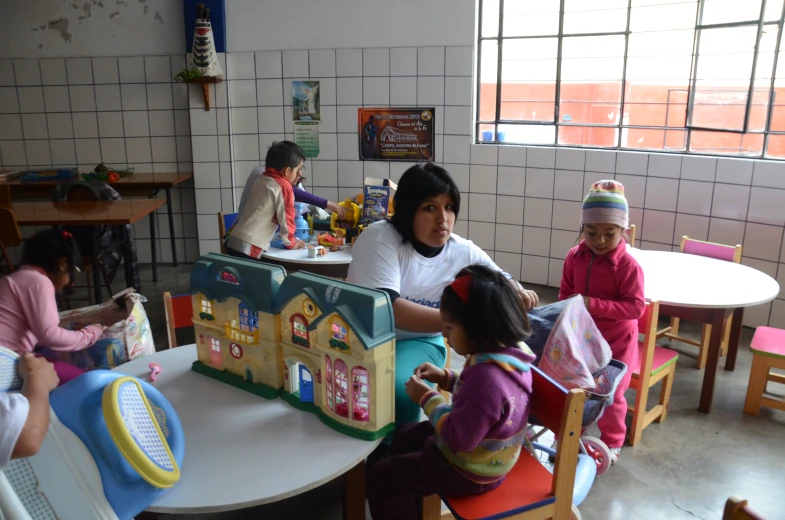 a group of children sit around a little girl