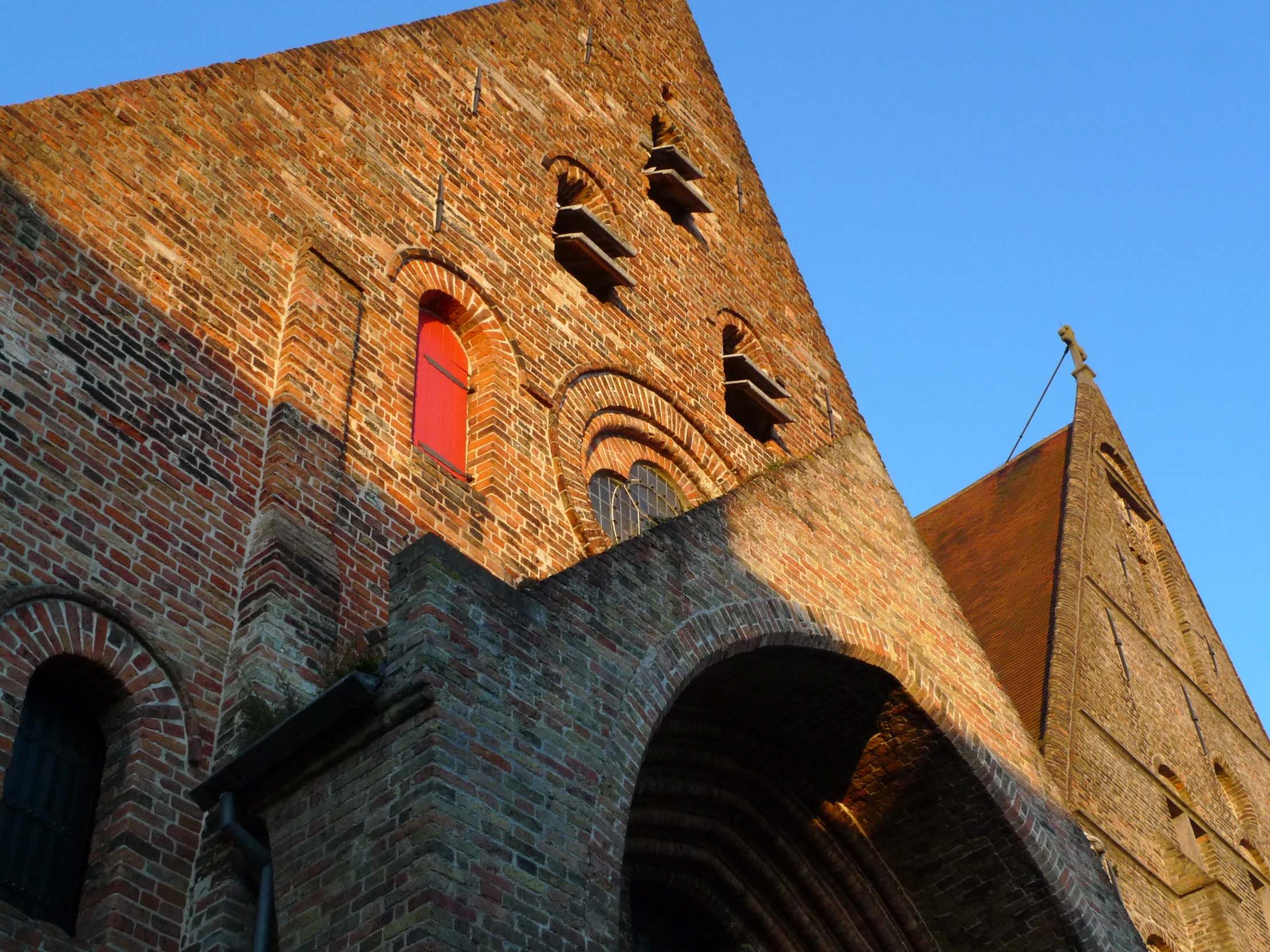 brick structure with two red doors and arches