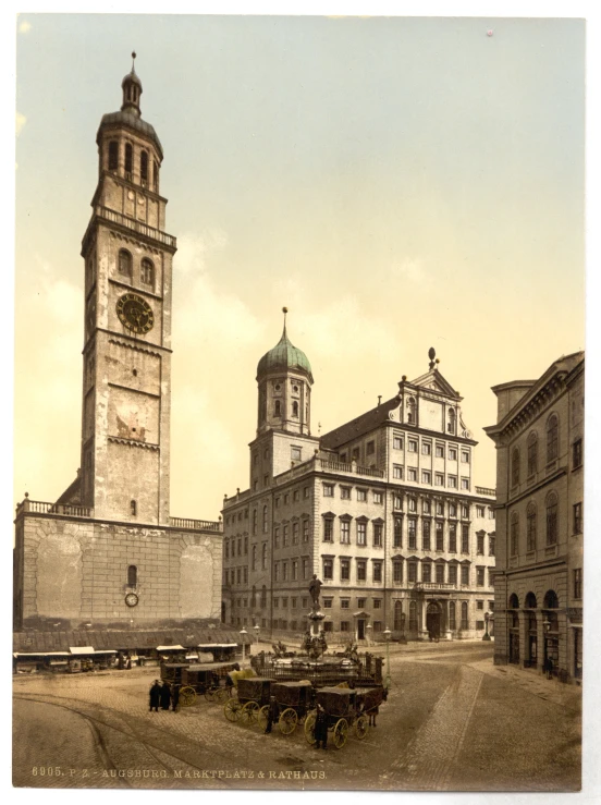 the clock is on the tower above the old cars