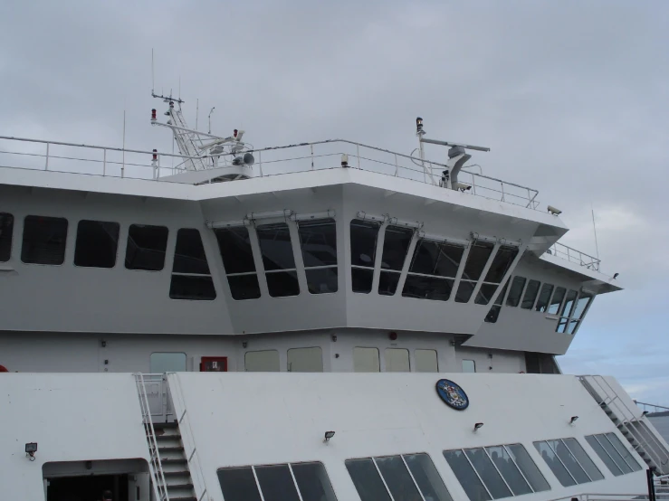 a man stands on the top deck of a cruise ship