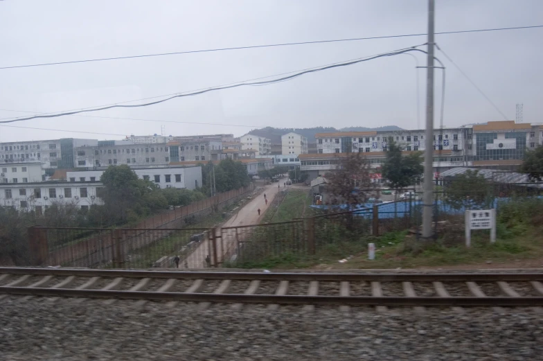 a city street from across the tracks on a overcast day