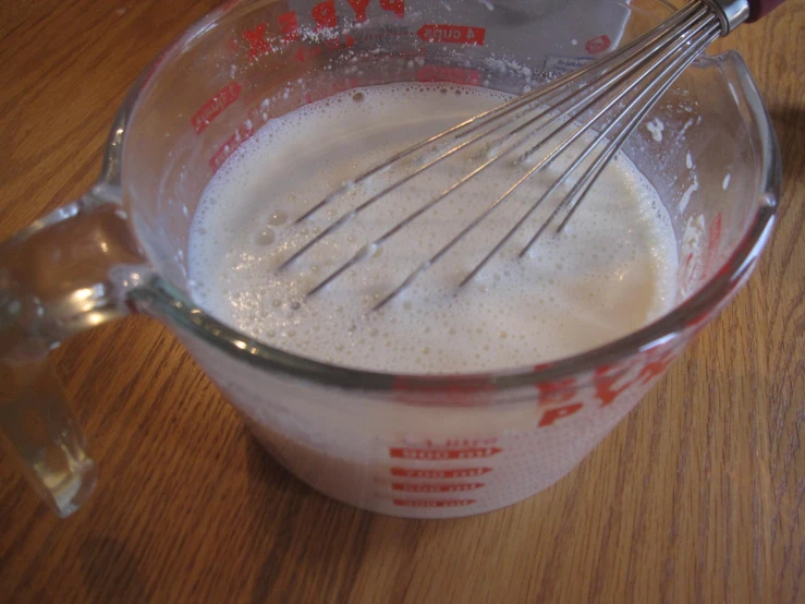 a measuring cup filled with a cream mixture