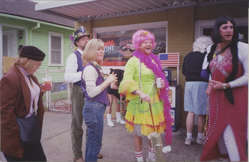 people dressed up in costume on the sidewalk in front of a building