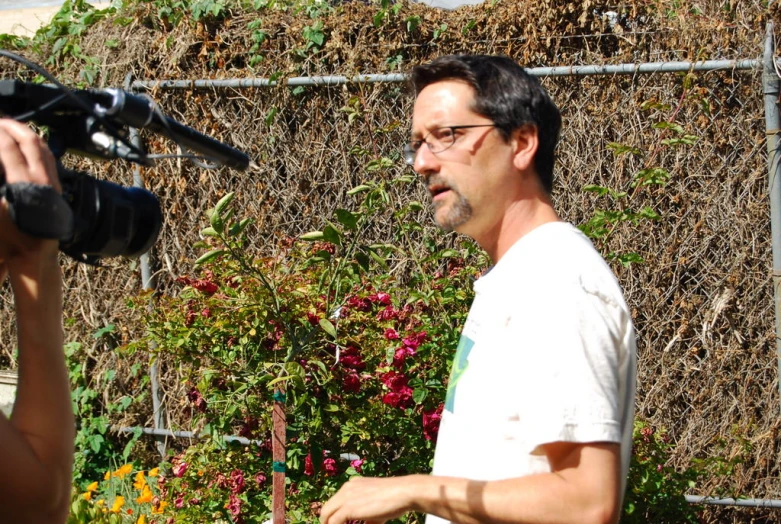 a man wearing glasses in front of a camera