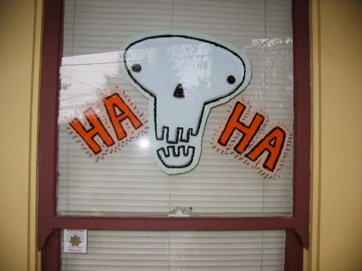 the window has an orange and black sign that says ha