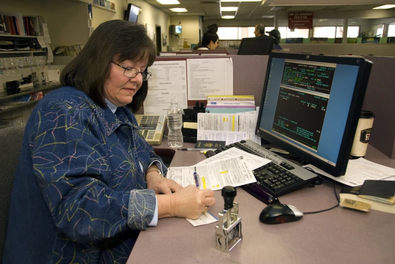 the lady is typing on a piece of paper