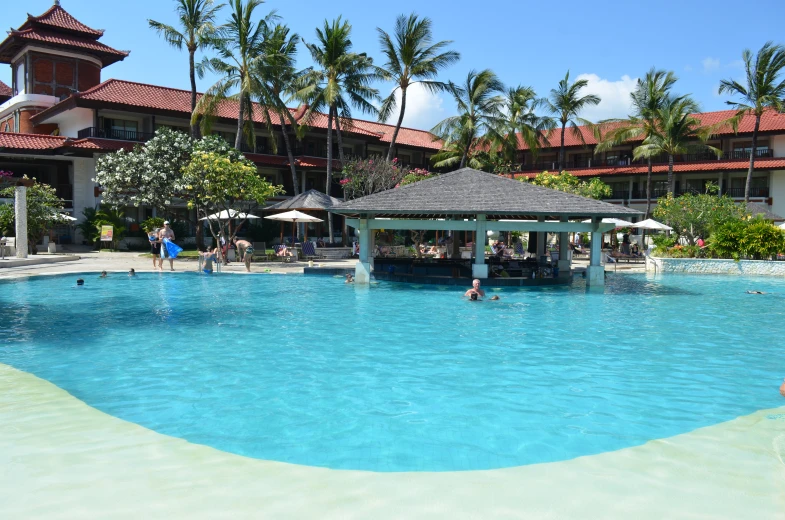 a large pool with people swimming and playing