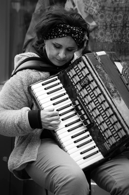 a person that is holding a very nice accordion