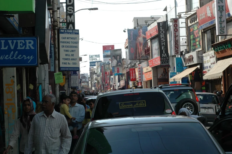 a very crowded city street filled with cars and people