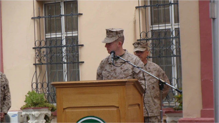 there are three men standing at a podium