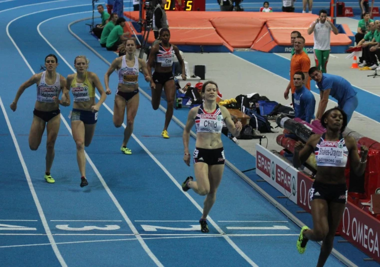 girls on their knees running through the track
