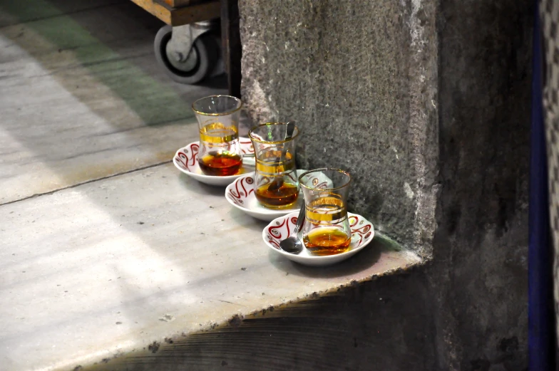 a group of three empty glass dishes filled with alcohol