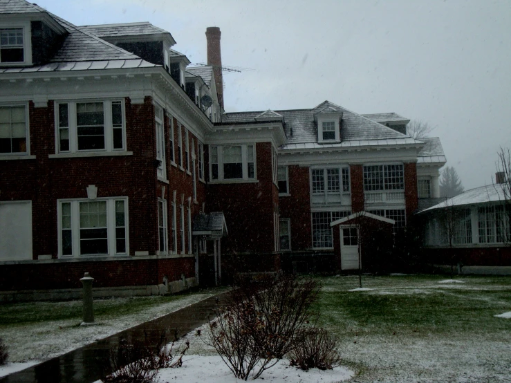 an old brick building is surrounded by snow