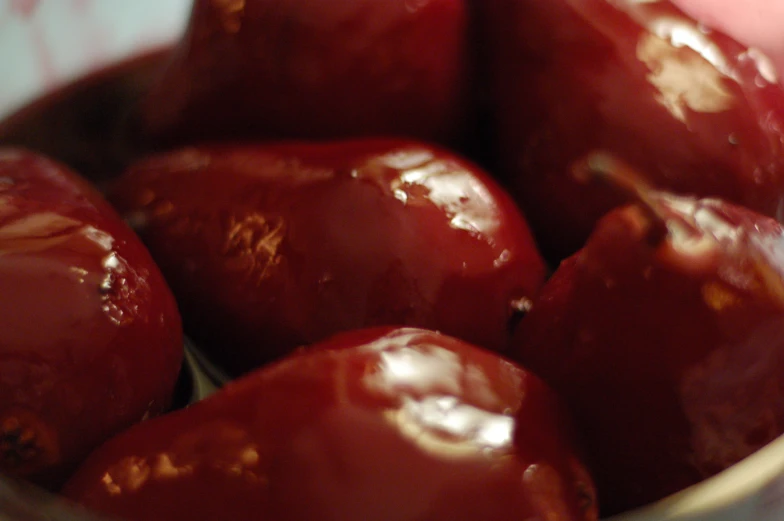 red apples have been eaten and are in a glass bowl