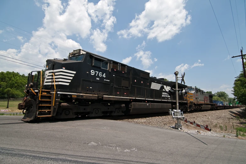 a train traveling down tracks near a rural town