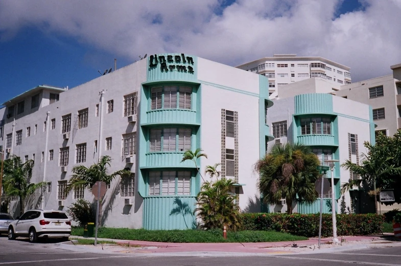 a white building with a green trim on the top