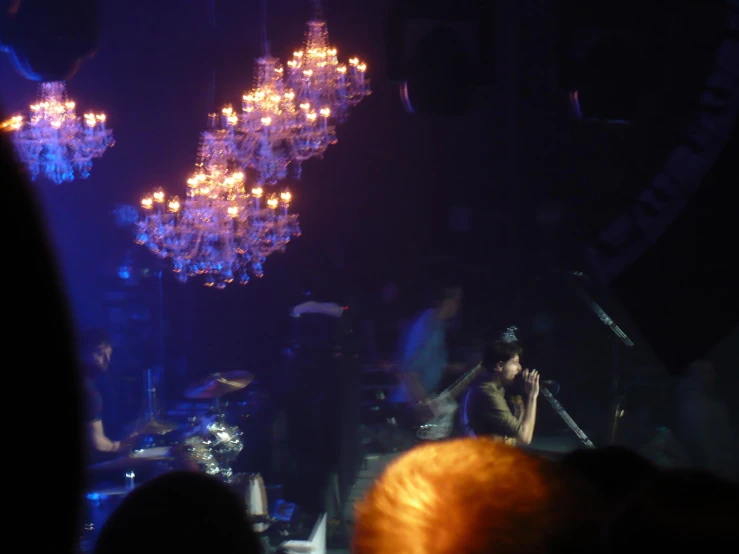 a group of people on a stage with lights