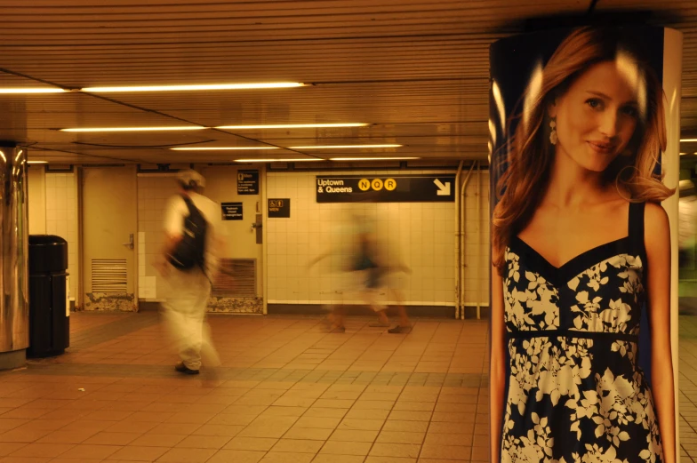 an image of a girl standing in a subway station