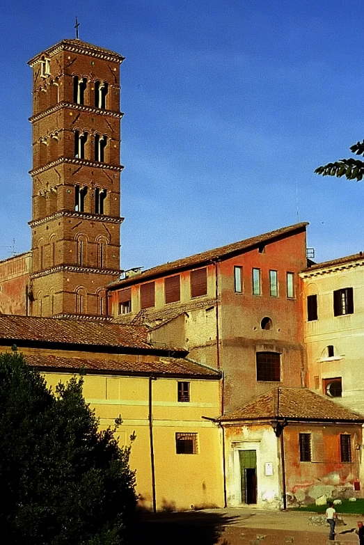 a large brick tower near many buildings