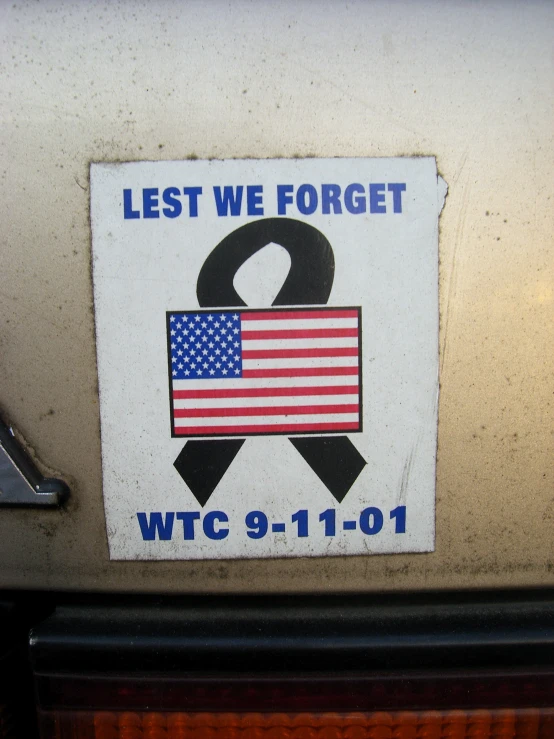 a sticker with a flag and a ribbon on it