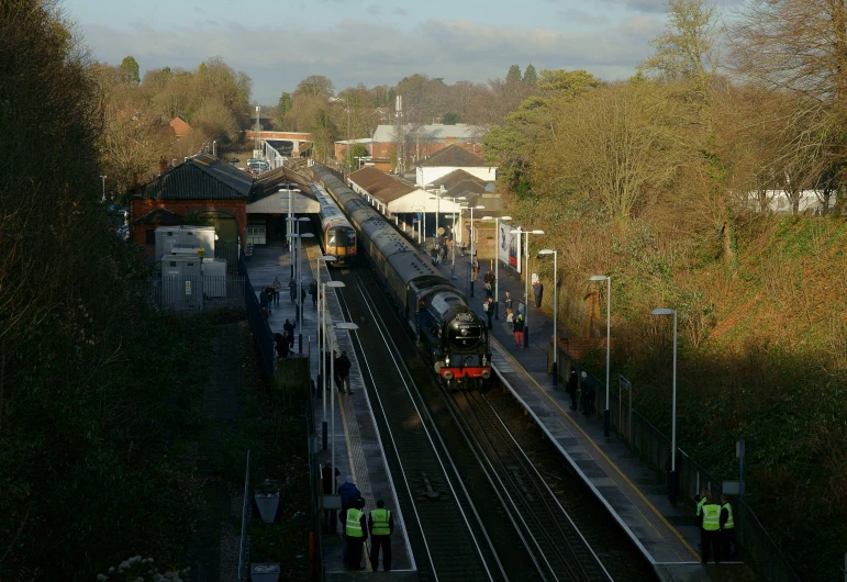 train tracks that are empty and there is a train pulling into it