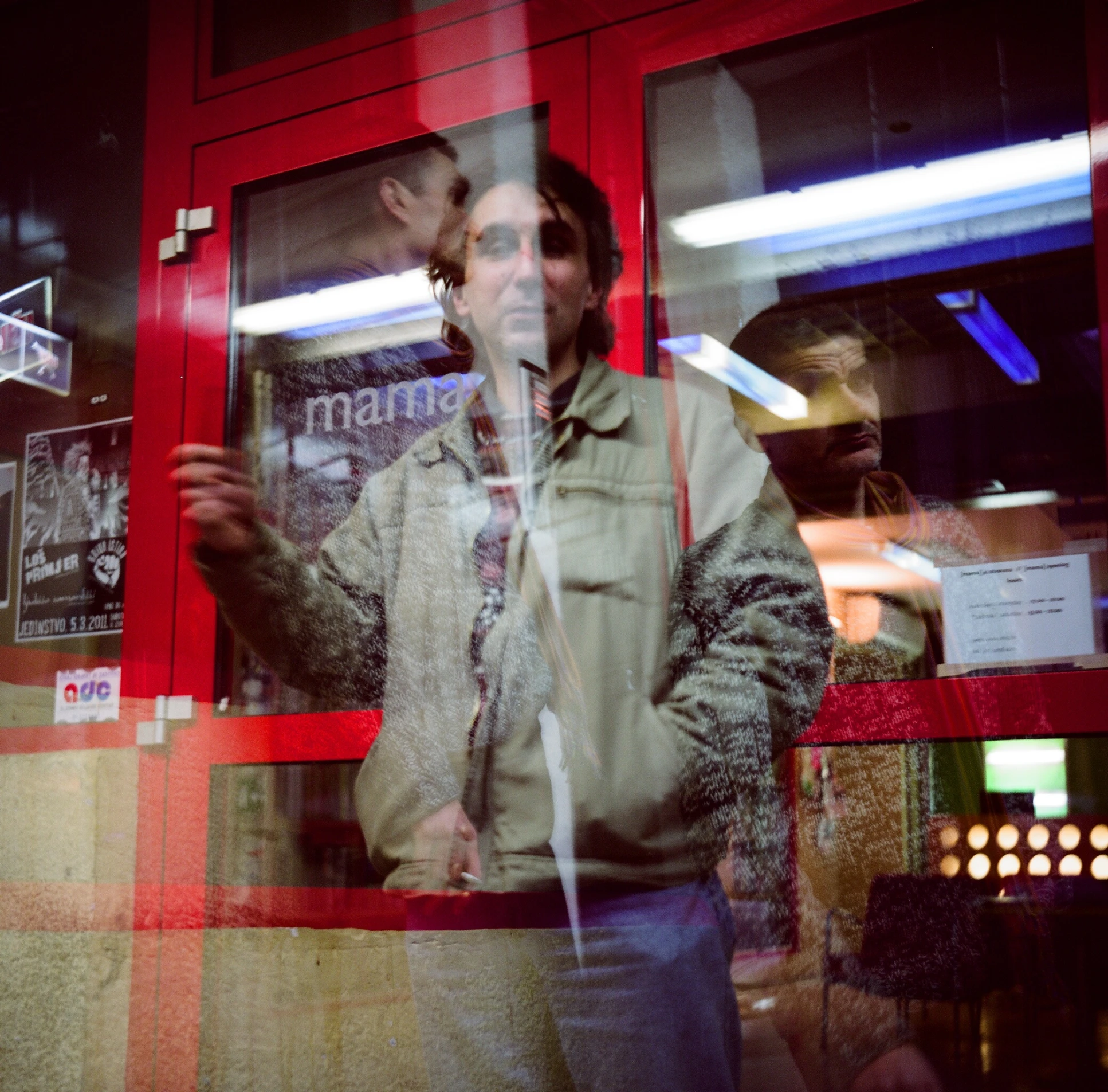 a man standing in front of a store window