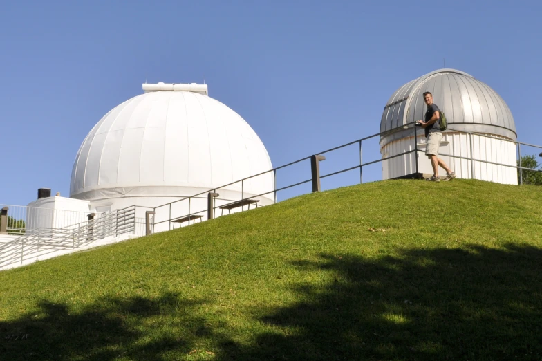 a person is standing next to the observatorys