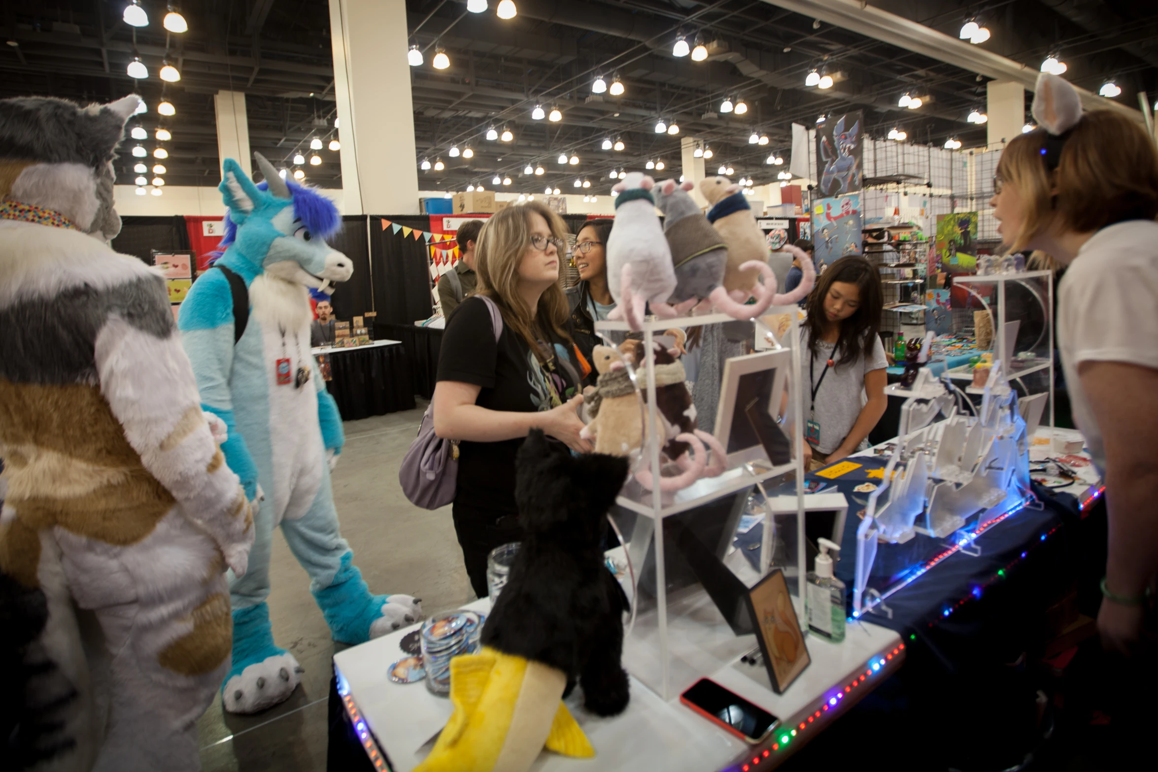 some people wearing mascot costumes near various items