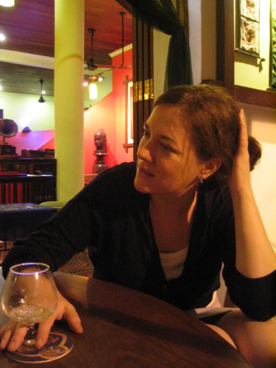 a woman sits at the table in a restaurant