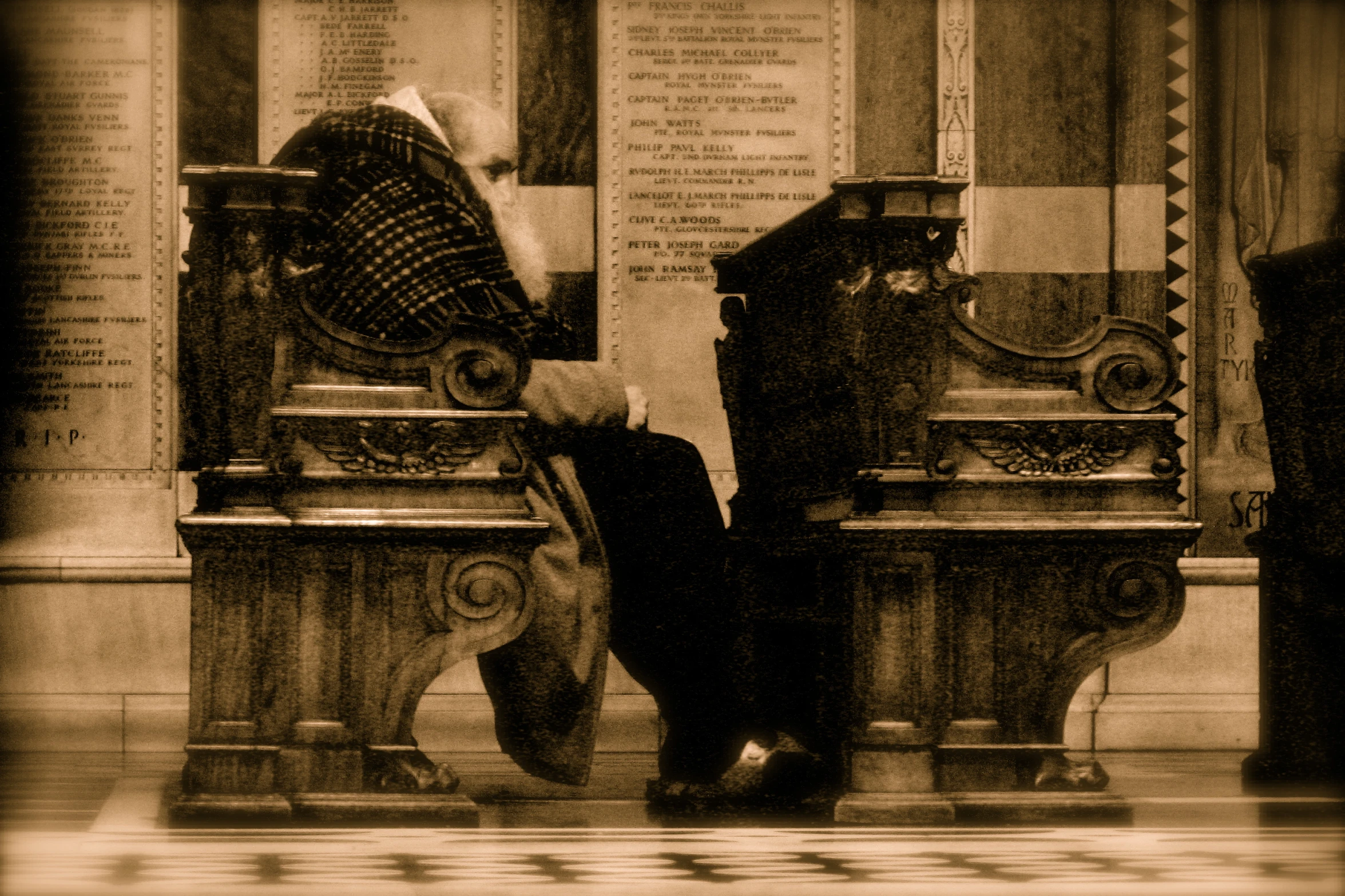 a pair of antique style benches in front of a sign