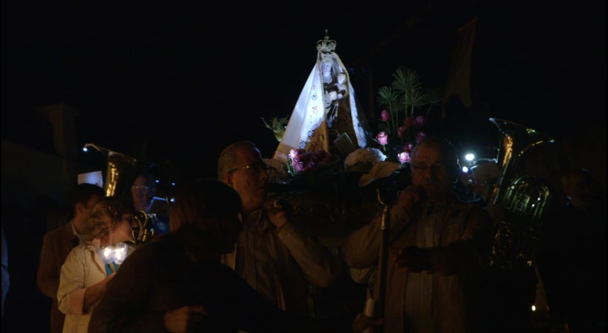 a large group of people standing around a small lite