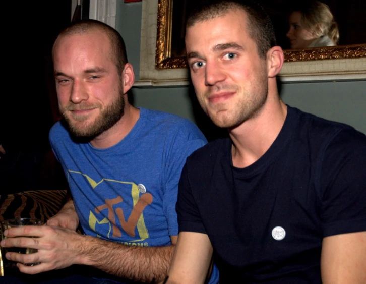 two people pose for a picture with a wine glass