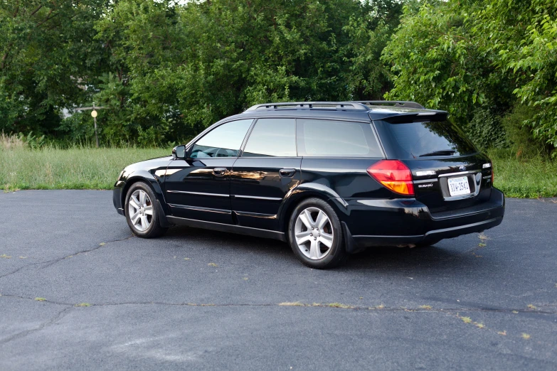 a black vehicle is parked in a parking lot