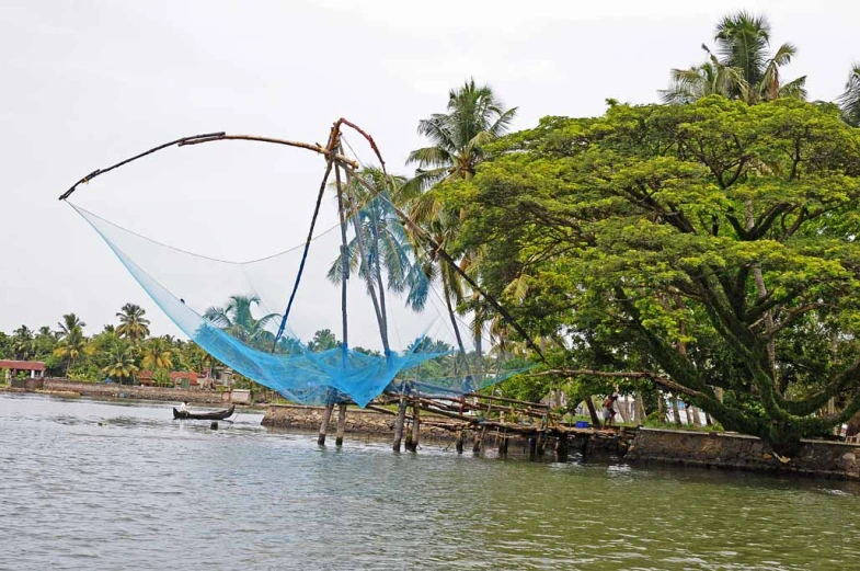 a man who is in the water with his fishing nets