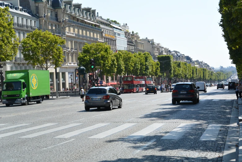 cars and trucks are traveling down the street in traffic