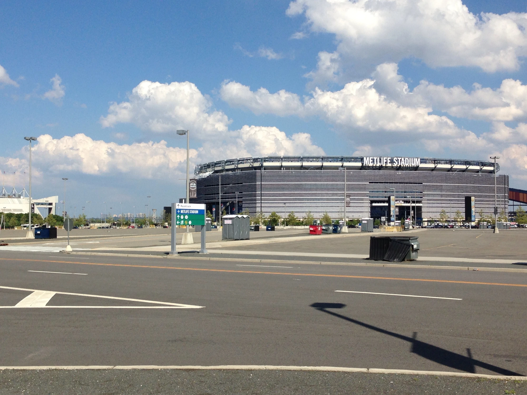 the empty parking lot in front of a large building