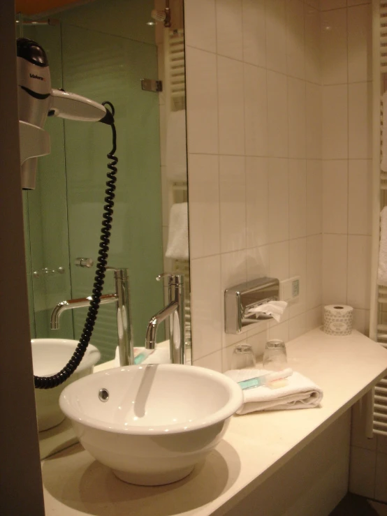 the faucet is beside the bathroom sink, on the counter