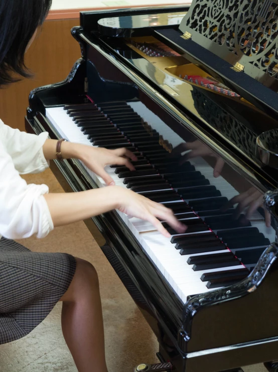 woman in dress and heels playing piano with musical instrument