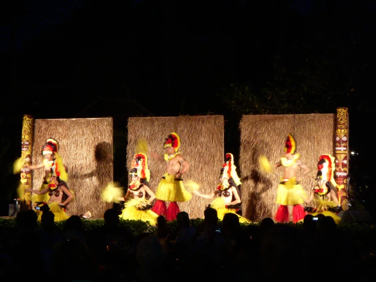 two dancers are dancing beside each other in front of a crowd