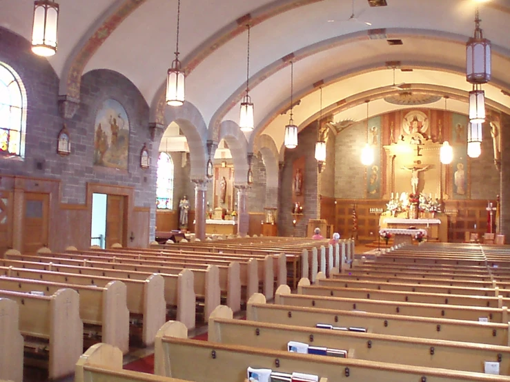 a large church filled with wooden pews and cross windows