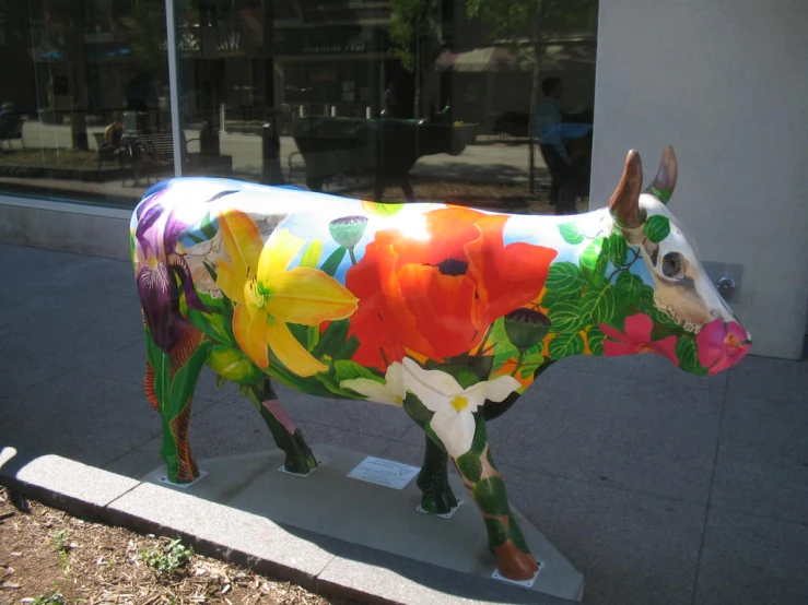 a cow painted like an oil paint on a platform