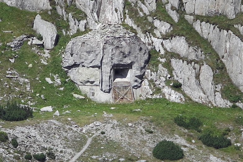 large rock formation with a cave in it