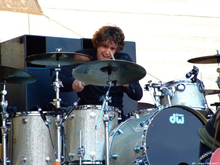 a man on a stage playing drums