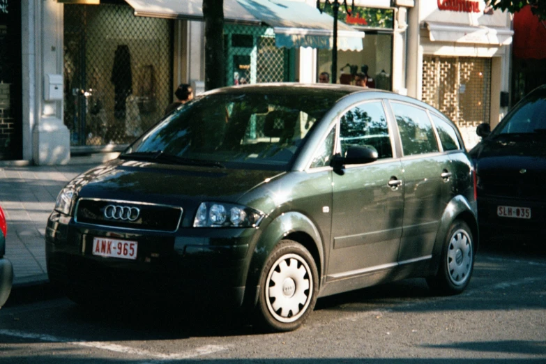 a car parked on a city street, in the sun