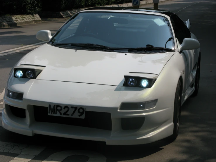 a white sports car with its hood down